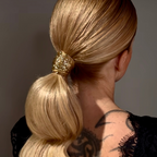 Model wearing Golden Blend biodegradable hair glitter in ponytail