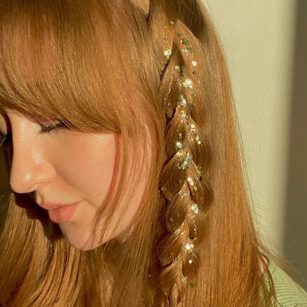 Model wearing Gold Mini Glam Kit in hair braids