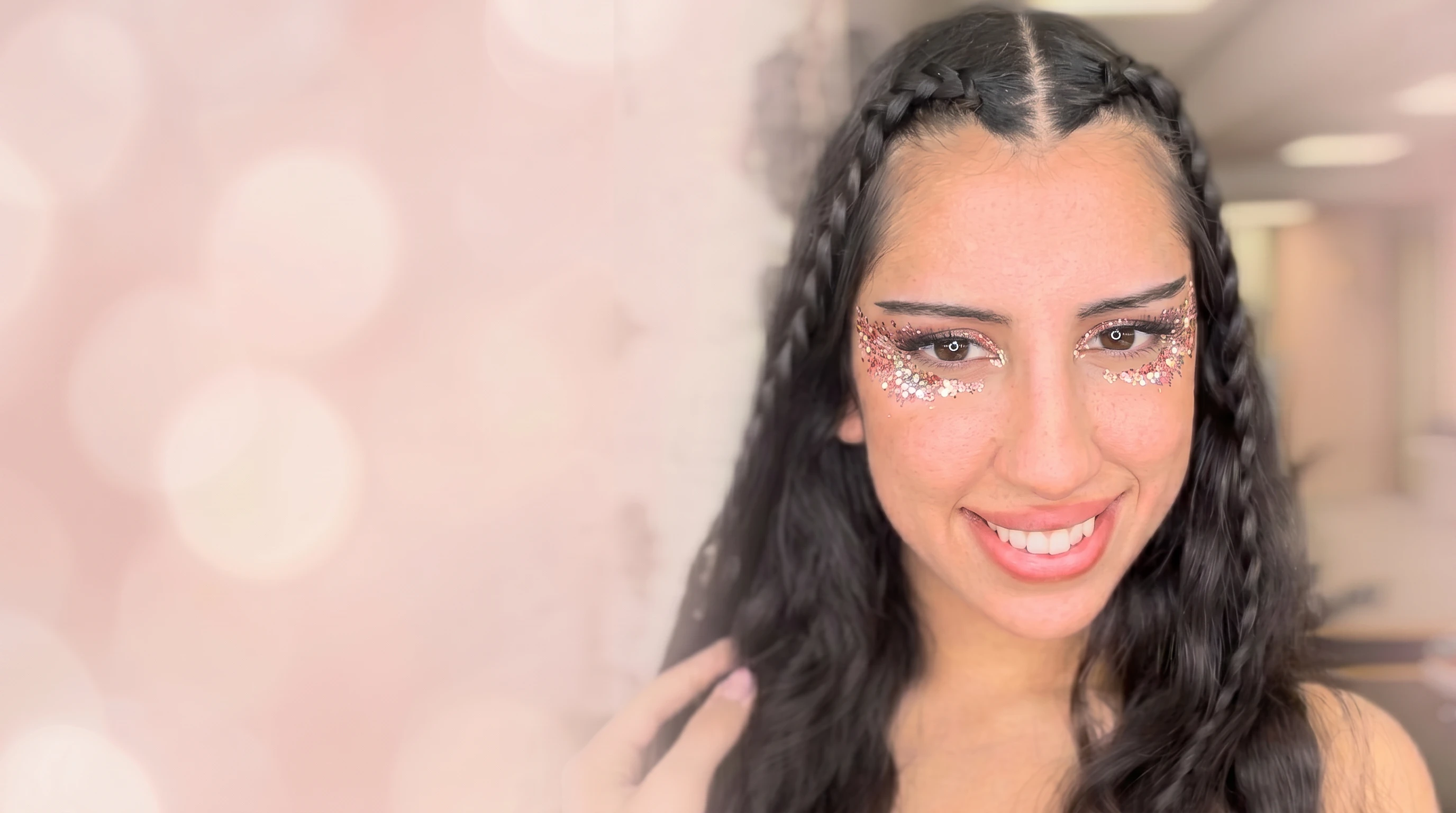 Model with braided hair wearing Glitter Eco Lovers plant-based pink and gold festival glitter