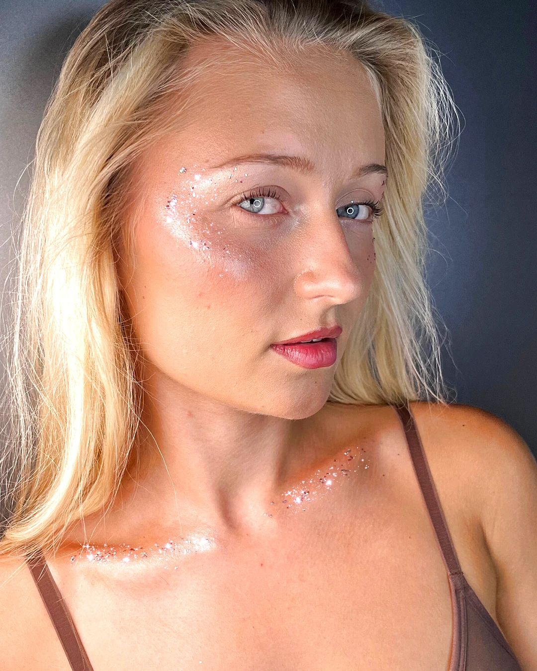 Rose-gold Glitter Eco Lovers glitter swept across the cheek and collarbone