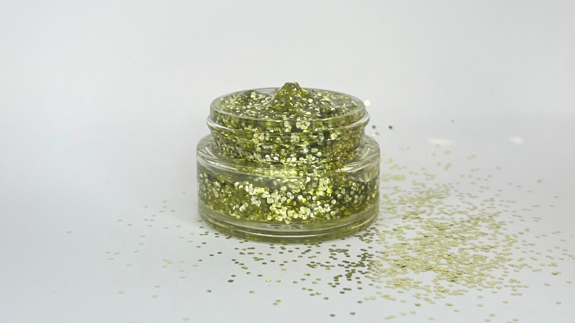 Concept image of Eco Lovers’ plant-based glitter gel in a glass jar — an early visual representation of the company’s work on plastic-free shimmer formulations.